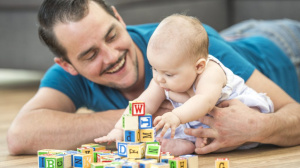 Dad playing with baby